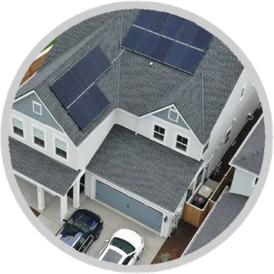 An aerial view of a house with solar panels on the roof An aerial view of a house with solar panels on the roof