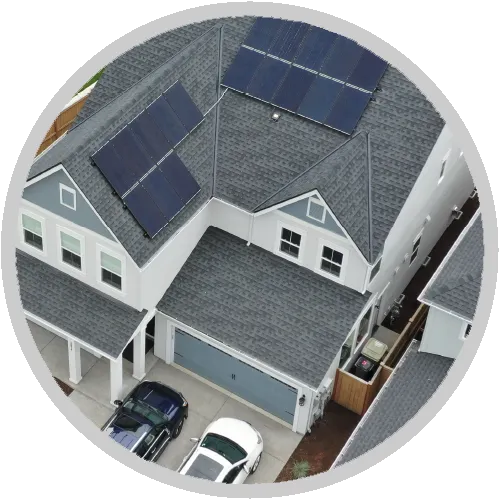 An aerial view of a house with solar panels on the roof An aerial view of a house with solar panels on the roof